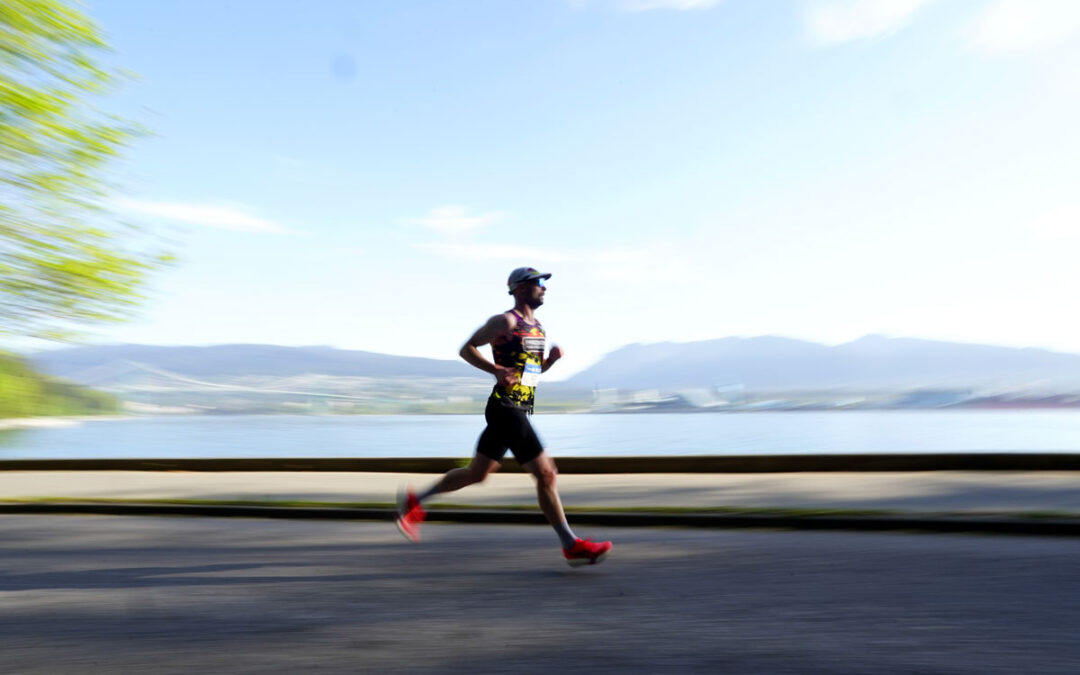 Runner on BMO Vancouver Marathon course over looking Vancouver Harbour